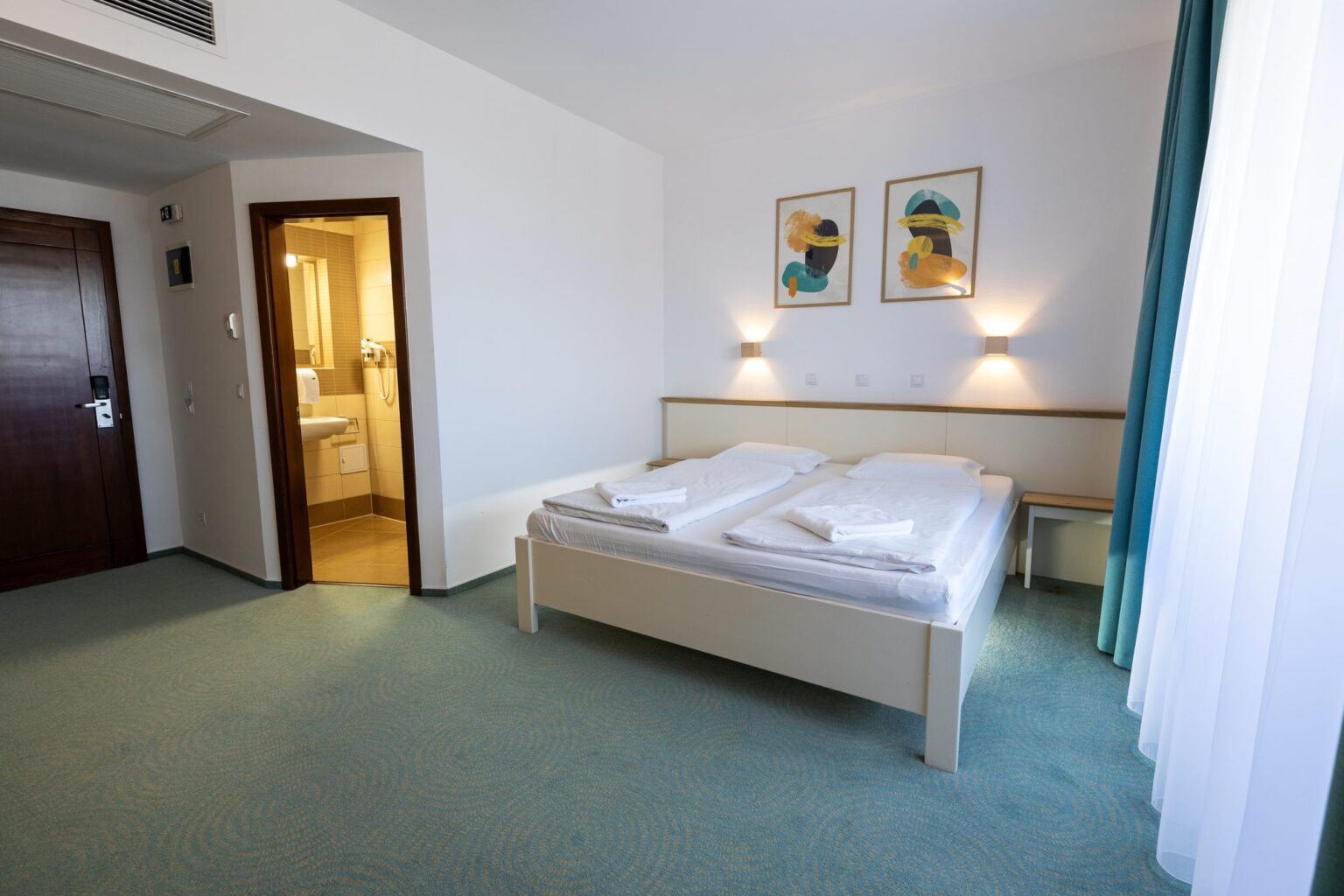 The double room seen from the window, with the bathroom door open
