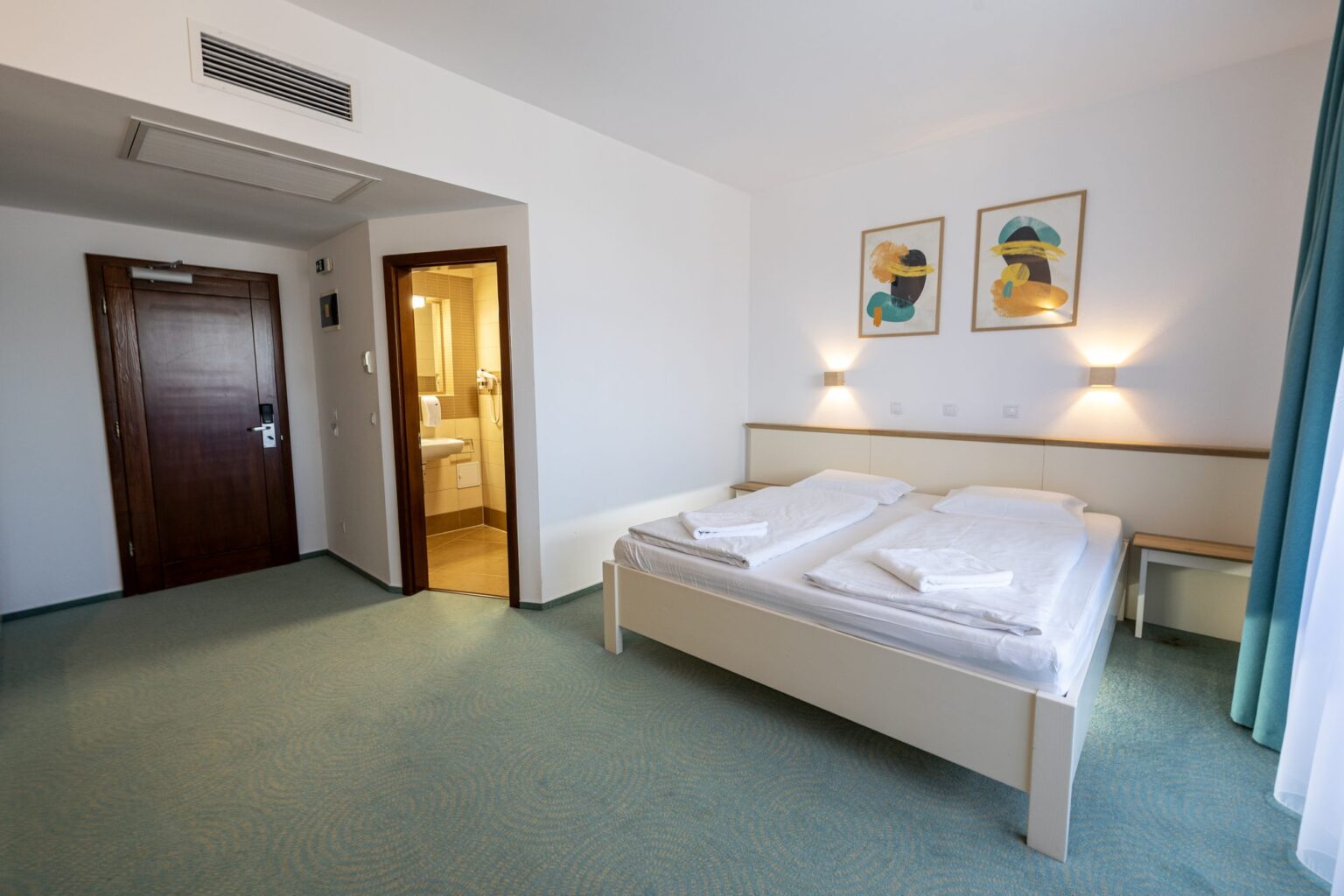 The double bed and the room entrance