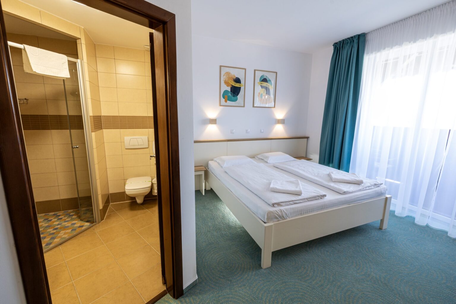 The shower room and the double bed by the large window