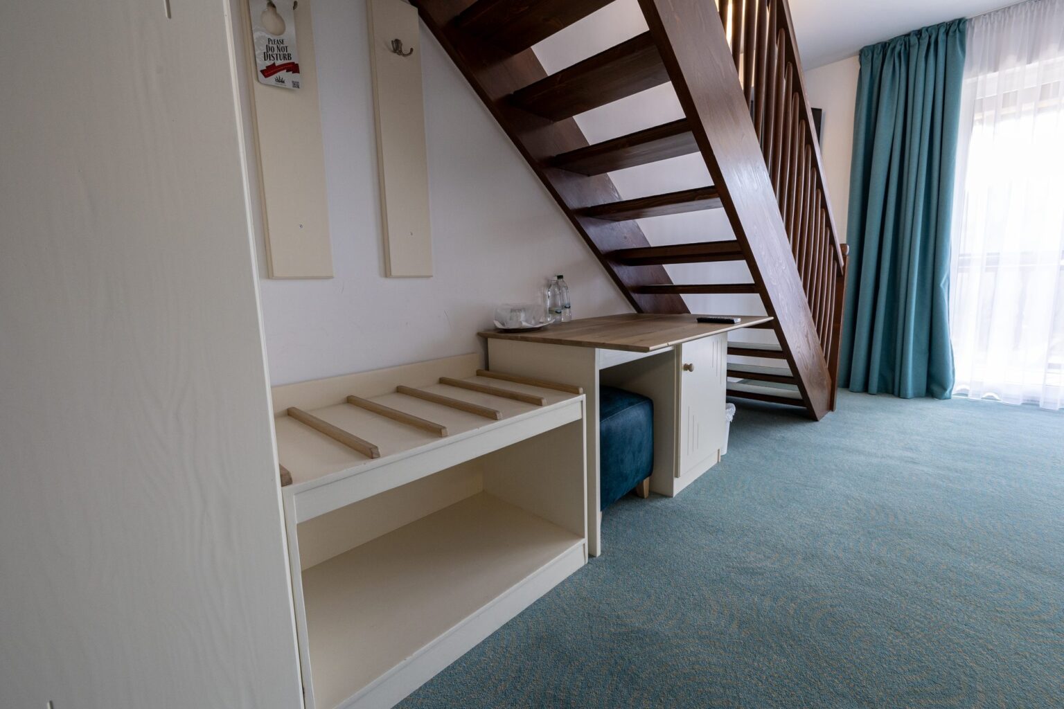 Junior Suite: the desk and luggage rack under the wooden stairs